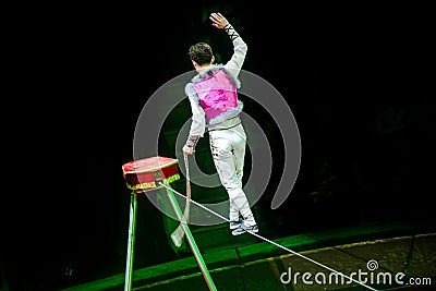 Acrobat walking on a rope Editorial Stock Photo