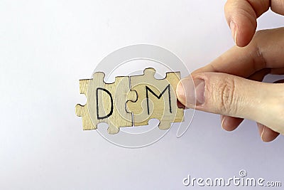 The acronym DM, which stands for Direct Message. The letters written on the puzzles. Stock Photo