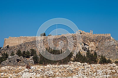 Acropolis on a hill in the city of Lindos. Fragment of residential buildings at the foot of the mountain. Editorial Stock Photo