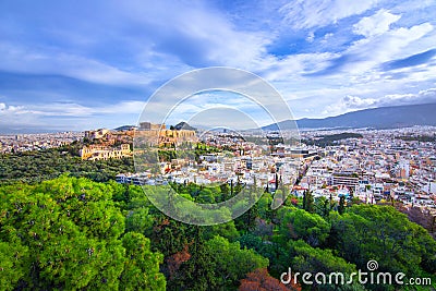 Acropolis with Parthenon. View through a frame with green plants, trees, ancient marbles and cityscape, Athens. Stock Photo