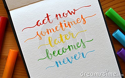 ACT NOW SOMETIMES LATER BECOMES NEVER hand-lettered in notebook Stock Photo