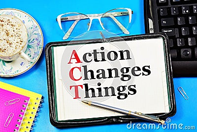 Action changes things. A text label in a working notebook. Stock Photo