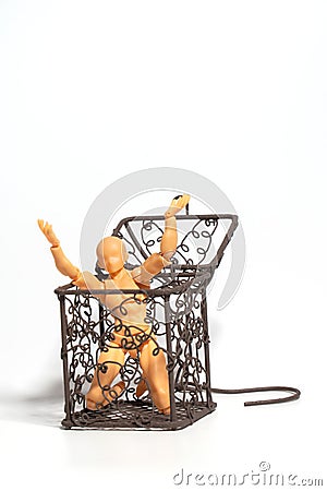 Action figure sitting and hold two hands above the head in open steel cage on isolate background, Concept of tolerance in comfort Stock Photo