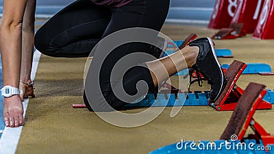 Action packed image of a female athlete leaving the starting blocks Stock Photo