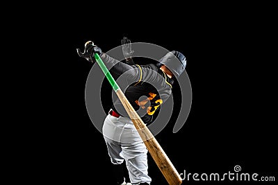 Professional baseball player, pitcher in sports uniform and equipment playing baseball isolated on black studio Stock Photo