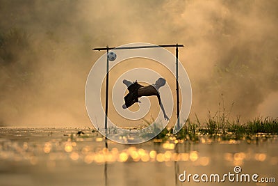 Action shot soccer silhouette boy jumping kick football Stock Photo