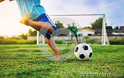 An action sport picture of a group of kids playing soccer football for exercise in community rural area Stock Photo