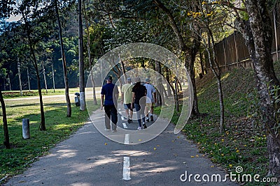 Active adults walking in Itaipava Municipal Park Editorial Stock Photo