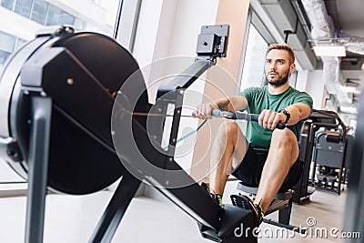 Active athlete man doing rowing workout Stock Photo