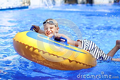 Active boy enjoying water slide in aquapark Stock Photo