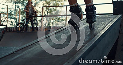 Active boy rollerblading at urban skate park for leisure. Rider roller skating. Stock Photo