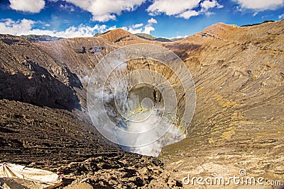 Active Bromo volcano mountain crater hole erupt with sulfur gas and smoke at Indonesia Bromo national park Stock Photo