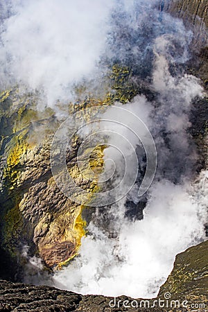 Active Bromo volcano mountain crater hole erupt with sulfur gas and smoke at Indonesia Bromo national park Stock Photo