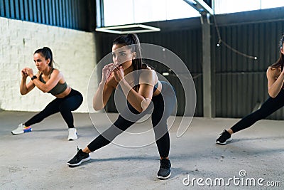 Active caucasian women working out in a HIIT class Stock Photo