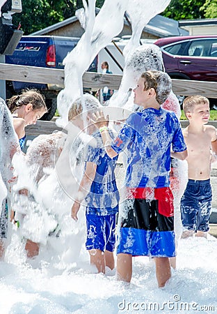 Active children play in bubbles and foam Editorial Stock Photo