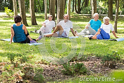 Active elderly people doing yoga Stock Photo