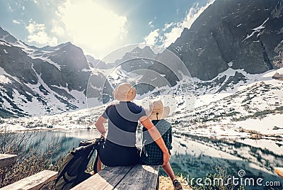 Active family leisure, spring summer hiking. Father and son rest near the mountain lake Stock Photo