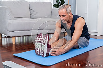 Active and fit senior man warmup and stretching before home exercising. Clout Stock Photo