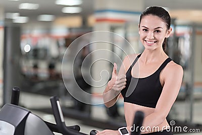 Active girl making an approving gesture with her thumb up Stock Photo
