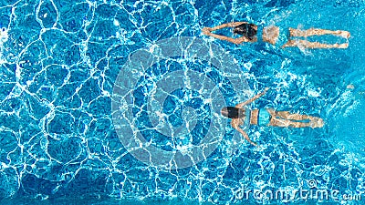 Active girls in swimming pool water aerial drone view from above, children swim, kids have fun on tropical family vacation Stock Photo