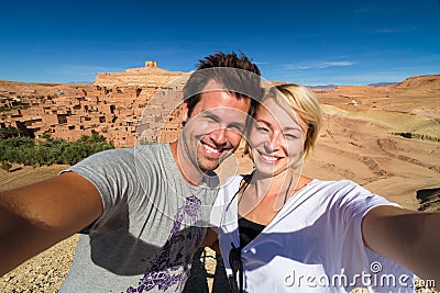 Active happy couple taking selfie on travel at Ait Benhaddou kasbah, Ouarzazate, Morocco. Stock Photo