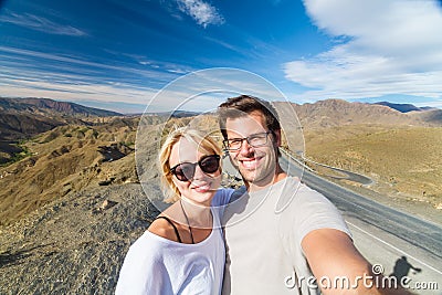 Active happy couple taking selfie on travel in high Atlas mountains, Ouarzazate, Morocco. Stock Photo