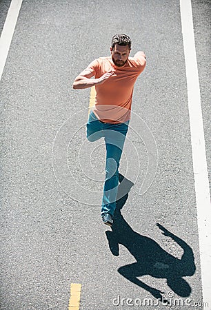 Active healthy runner jogging outdoor. Man running on the road. Stock Photo