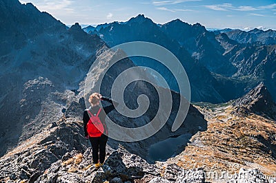 Active life in mountains, Female hiker watching the beautiful scenery in mountains. High Tatras, Slovakia Editorial Stock Photo