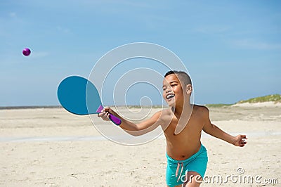 Active little boy playing at the beach Stock Photo