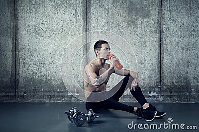 Active man with water bottle and dumbell Stock Photo