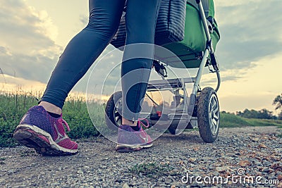 Active mother running with baby stroller. Stock Photo