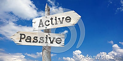 Active, passive - wooden signpost with two arrows Stock Photo