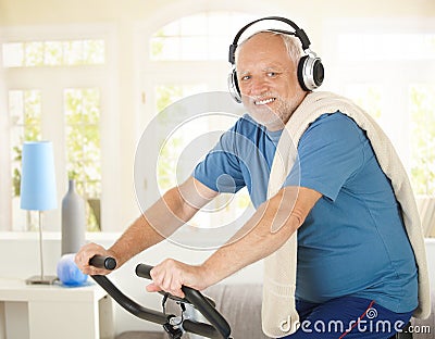 Active pensioner doing spinning with music Stock Photo