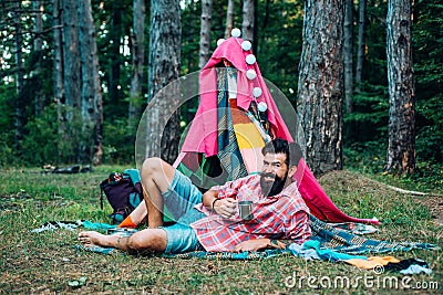 Active people. Play tent. Hovel decorated party. Homemade tent - hut. Adventure travel. Camping and tent near beautiful Stock Photo