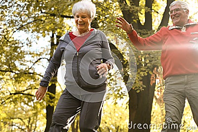 Active senior couple together in park having fun. Stock Photo