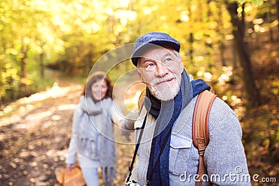 Senior couple on a walk in autumn forest. Stock Photo