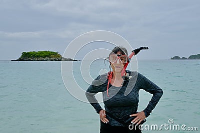 Active Senior Woman With Snorkel Gear Standing in Tropical Bay Stock Photo