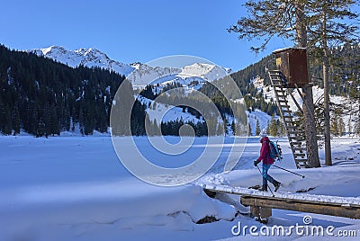 Active senior woman snowshoeing in Vorarlberg, Austria Stock Photo