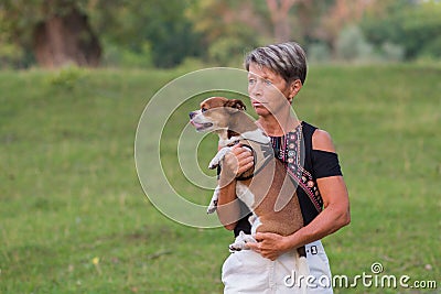 Active seniors fashion woman holding her small dog Stock Photo