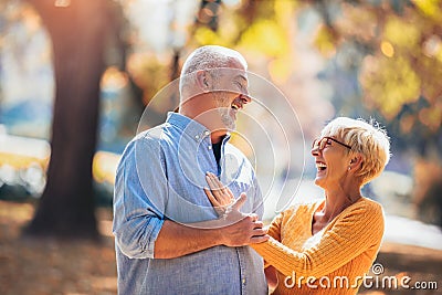 Active seniors on a walk in autumn forest Stock Photo