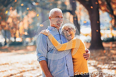 Seniors on a walk in autumn forest Stock Photo