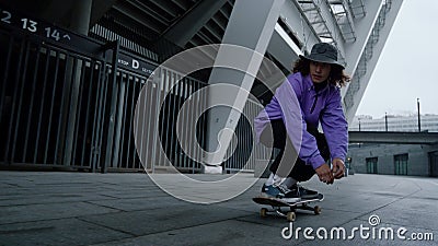 Active skater practicing kickflip outdoor. Hipster jumping on skate in stadium. Stock Photo