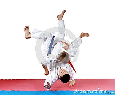 Active small athletes in kimono make tall throw Stock Photo