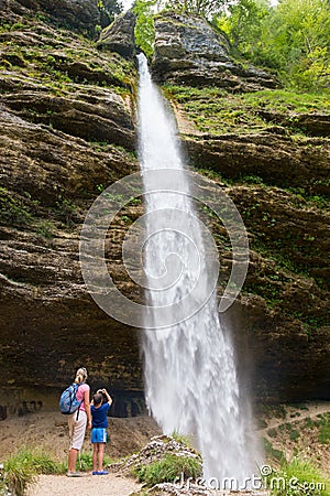 Active tourists looking at Pericnik waterfall in Vrata Valley in Triglav National Park in Julian Alps, Slovenia. Editorial Stock Photo