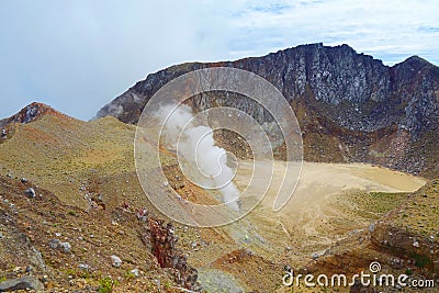 Active volcano Mount Egon with a caldera and sulfuric gasses coming from within the volcano on East Nusa Tenggara, Flores, Stock Photo