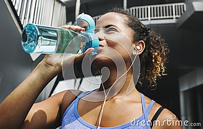 Active woman drinking water after exercise Stock Photo