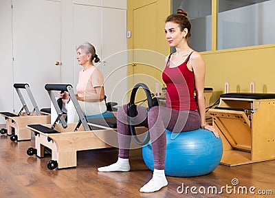 Active women perform exercises with fitness balls and Pilates rings Stock Photo