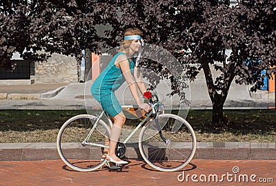 Active women in vintage clothing cycling in city park during the festival Retro Cruise Editorial Stock Photo