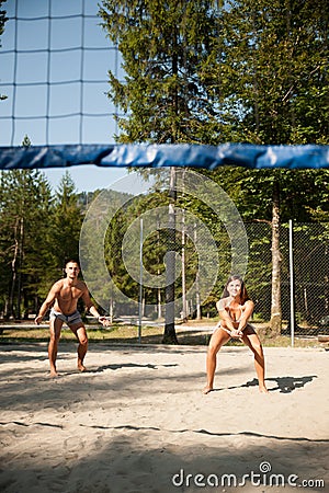 Active young couple play beach volley on hot wimmer day Stock Photo