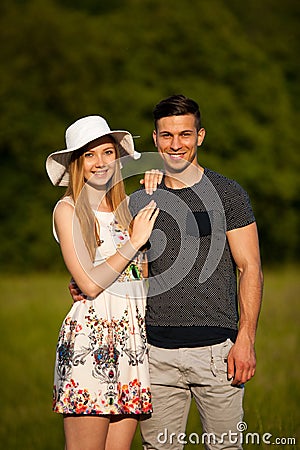 Active young couple on a wlak in the park on hot summer afternoon Stock Photo